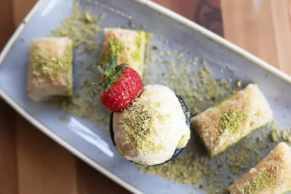 Traditional baklava with pistachio and a scoop of ice cream, a sweet delight at Inco Turkish Restaurant & Fish Bar in Romford.