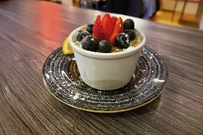 A delicious dessert topped with fresh strawberries and blueberries, a sweet treat at Inco Turkish Restaurant & Fish Bar in Romford.