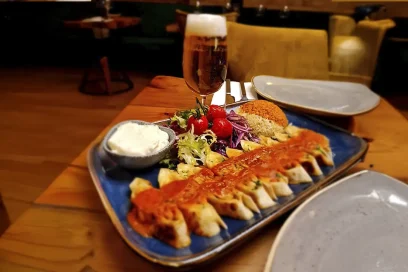 Savour the delicious taste of doner kebab served with rice, fresh salad, and a chilled drink at Inco Turkish Restaurant & Fish Bar in Romford.