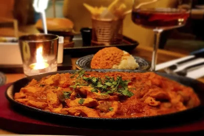Savour the rich flavours of spicy pasta, served with fragrant rice and a refreshing drink, at Inco Turkish Restaurant & Fish Bar in Romford.