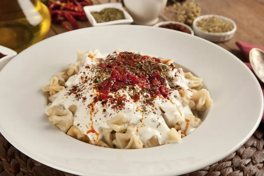 Traditional Turkish dumplings called Manti, served with yoghurt and garlic sauce.